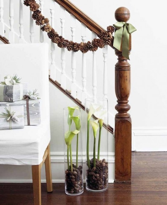 a pinecone garland with green bows is a perfect banister decoration, it will bring a cozy woodland feel to the space instantly