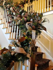 an evergreen garland with leaves, large ribbon bows and shiny ribbon is a very cool and eye-catching idea