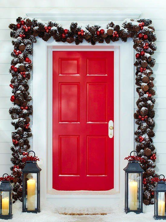 a fab Christmas garland of evergreens, pinecones, red ornaments is a cool decor idea for both indoors and outdoors, it will add color