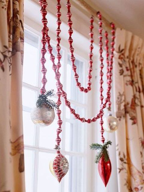 a holiday garland of beads and vintage ornaments is a cool idea to style your space for Christmas