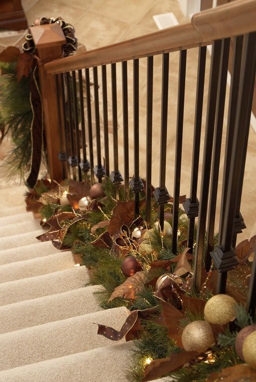 an evergreen garland with brown and gold ornaments, faux leaves and ribbon is a very eye-catching idea for elegant Christmas decor