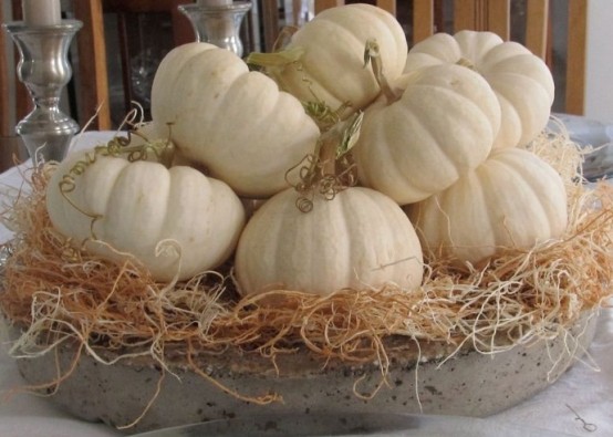 a concrete tray with hay and white pumpkins is a rustic fall centerpiece in neutral shades