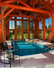 a large and cozy pavilion done with faux stone and stained wood, with a large pool, a stone deck and fantastic views of the surroundings is amazing
