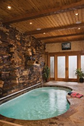 a stone wall looks great by an indoor pool