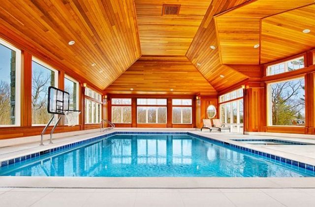 a large glazed pavilion with a stained wood ceiling is a perfect idea for a cold climate, it lets enjoy swimming any time