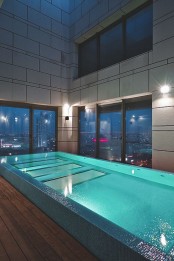a large indoor pool with gorgeous views of the city is a fantastic idea for a modern or contemporary space, it welcomes in and brings relaxation