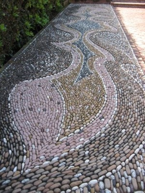 a gorgeous pebble pathway done with patterns in several colors - pink, blue and tan to add pattern and colro to your space