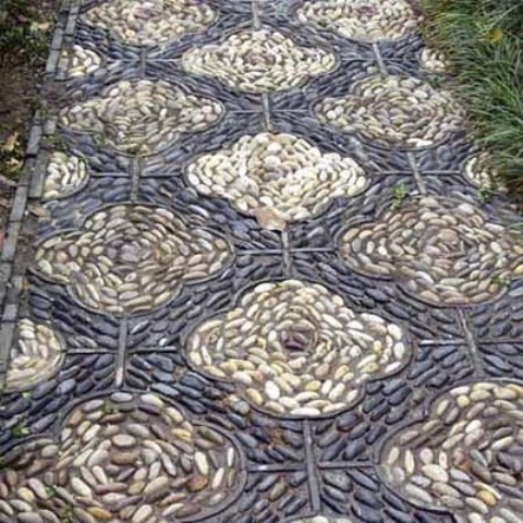 a black and neutral pebble garden path with a floral pattern and lining will give a vitnage feel to your outdoor space
