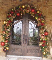 gold, red, green ornaments and striped ribbons and evergreens over the doors to bring a festive feel to the outdoor space