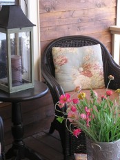 bright potted blooms and printed throws wil easily bring a spring feel to your porch