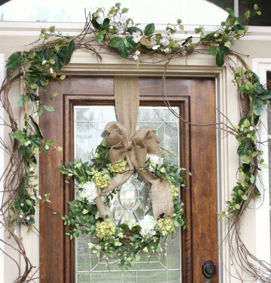 faux greenery, white and green blooms plus vines and a wreath on burlap for a rustic spring porch