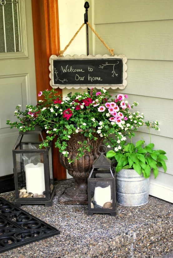 bright blooms and greenery, candle lanterns and a chalkboard sign for simple and cute spring porch decor