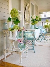 white and green blooms, foliage, blue jars and vases for a vintage-inspired spring porch