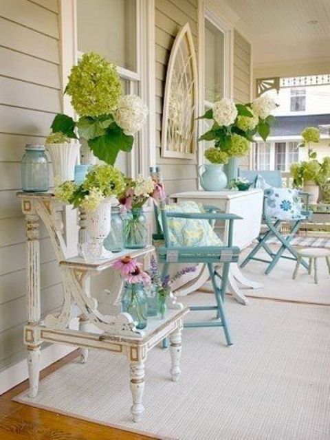 white and green blooms, foliage, blue jars and vases for a vintage-inspired spring porch