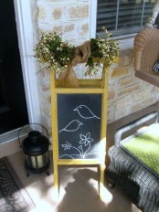 a chalkboard sign with fresh blooms wrpaped in burlap for a rustic spring porch