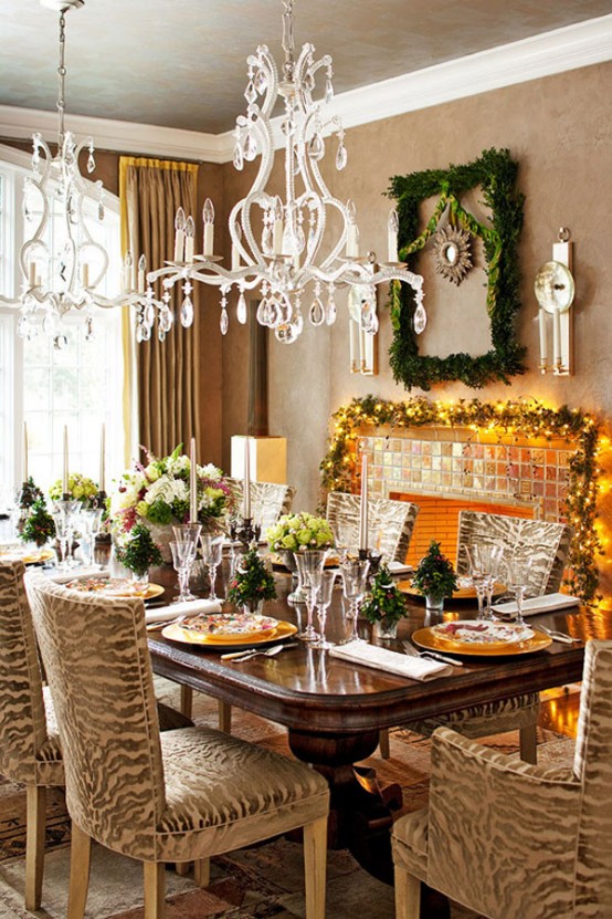 a refined Christmas tablescape with lush floral arrangements, mini Christmas trees, gold placemats and printed plates