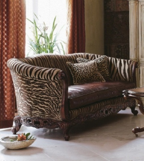a vintage-inspired brown sofa with zebra print upholstery and a leather seat is a stylish idea for a refined vintage living room