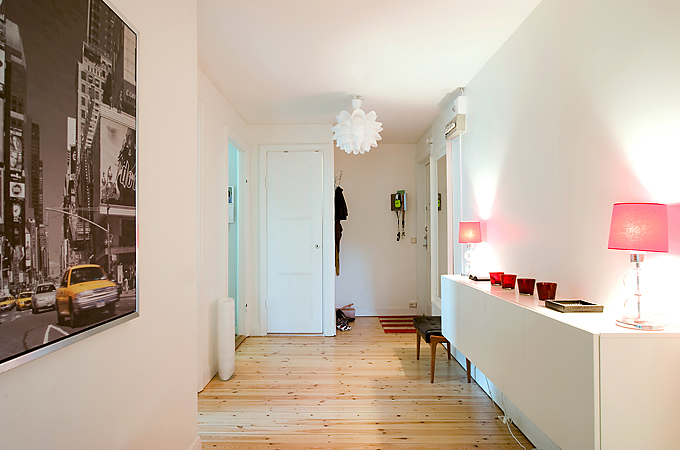 Apartment With Light Wood Floors & Painted White Walls