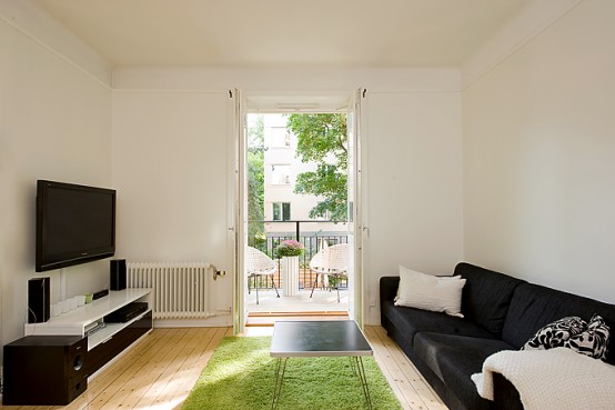 Apartment With Light Wood Floors & Painted White Walls