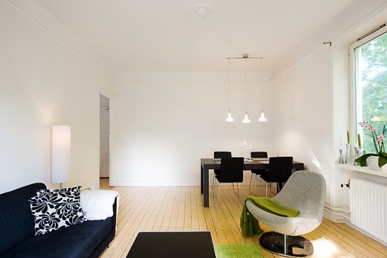 Apartment With Light Wood Floors & Painted White Walls