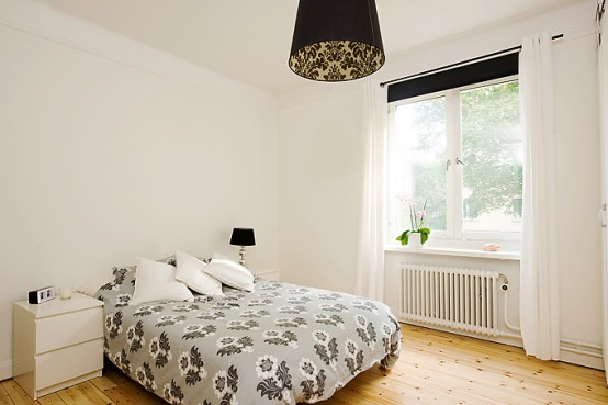 Apartment With Light Wood Floors & Painted White Walls