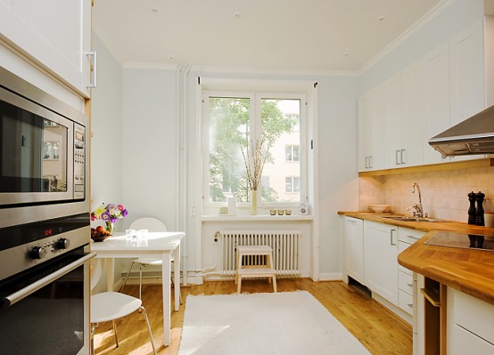 Apartment With Light Wood Floors & Painted White Walls