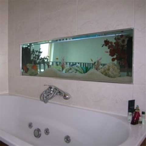 a built-in aquarium over the tub is a cool decor feature to feel like swimming in the sea