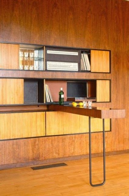 a yellow plywood wall unit with closed storage compartments and a bar countertop on a hairpin leg