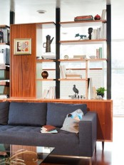 a large storage unit that acts as a space divider, open shelves and storage compartments is a very functional idea