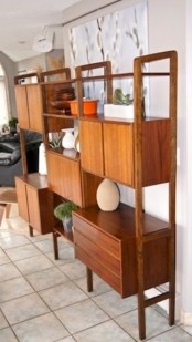 a large storage unit featuring cabinets and open shelves is a stylish idea for a mid-century modern interior