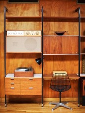 a large rich-stained wall unit with closed storage compartments, drawers and open shelves plus a mini desk integrated