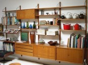 a large wall-mounted storage unit with cabinets, drawers and shelves including slanted ones, all placed symmetrically