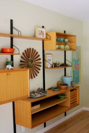 a chic and lightweight wall-mounted shelving unit with open shelves and open box shelves plus some drawers
