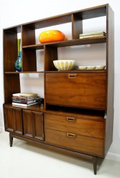 a dark stained wooden storage unit with closed and open compartments, legs will accommodat e alot of stuff