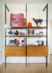 a bold mid-century modern wall unit with dark metal touches, cabinets and open shelves and drawers
