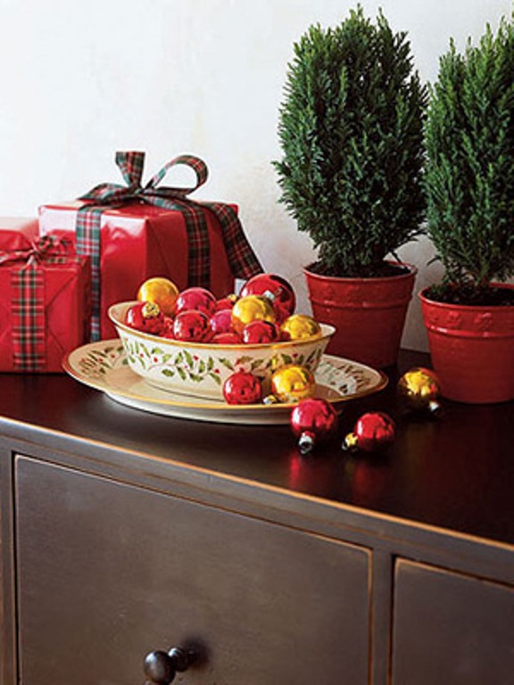 a bowl with gold and red Christmas ornaments is a cool decoration or centerpiece for winter holidays