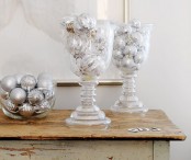 frosted glass jars and a bowl with silver ornaments are nice to decorate tables, shelves, a mantel and other places