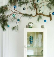 attach a branch and hang some Christmas ornaments on it to make your space more festive and bright
