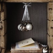 an arrangement of white and silver ornaments for Christmas is a chic and stylish idea to accent even a small nook