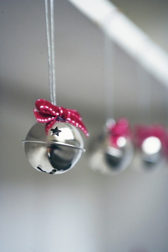 mini silver bells with stars and red ribbon bows are cute as ornaments for Christmas and holidays on the whole
