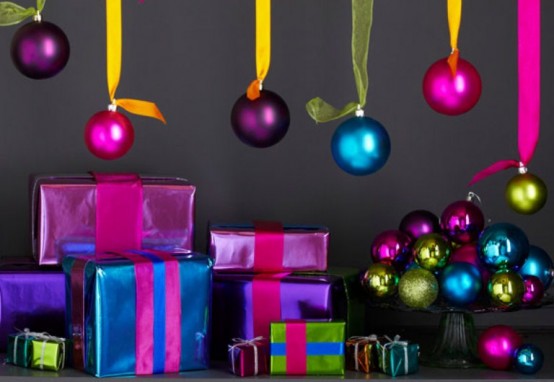 colorful Christmas ornaments hanging over the space and in a bowl are amazing for holiday spaces