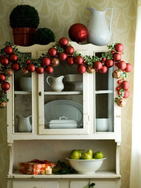 a holiday garland of colorful ornaments and foliage is a cool decoration for Christmas spaces - from kitchens to living rooms