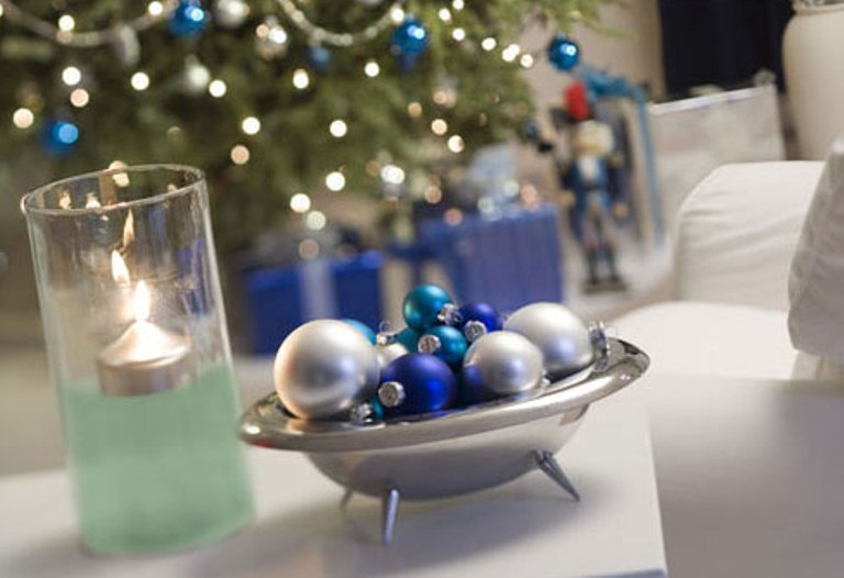 a silver bowl with silver, blue and turquoise ornaments can be used as a decoration or as a centerpiece