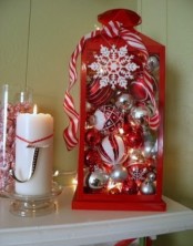 a red lantern filled with white, red and silver ornaments plus snowflakes for simple and cute Christmas decor