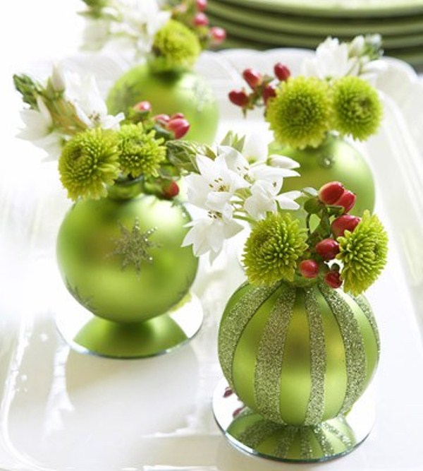 colorful Christmas ornaments used as mini vases for blooms and berries is a cool idea for any holiday table
