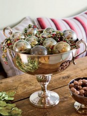 a vintage silver bowl with matching Christmas ornaments and colorful beads is a nice and elegant Christmas centerpiece
