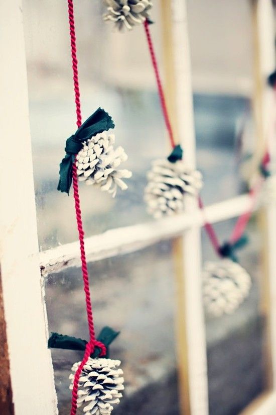 Here is a cool idea if you like want to hang a pinecone garland on your window. Add a personal touch to it by painting pinecones in white and adding black ribbon scraps to them. It's a great solution if you like black and white color scheme for Christmas.