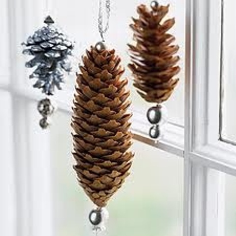 Add little ornaments to pinecones to make them look even cooler than they are.