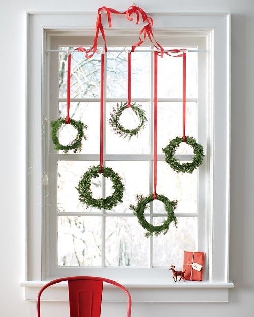 Several hanging wreaths would make a striking impact on your window's look.