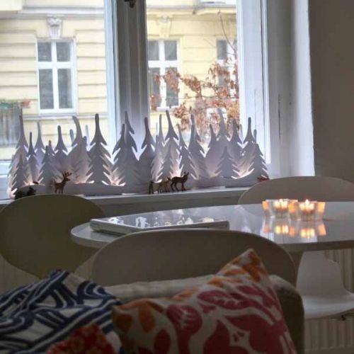 We all know how easy it is to cut paper snowflakes. Although there are lots of other interesting things you could cut from paper for your Christmas decor. For example, a whole evergreen forest you could put on your windowsill. Several lights hidden in it would make it looks even cooler.